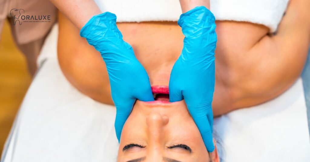 Patient receiving jaw pain treatment consultation at Oraluxe Clinic Delhi